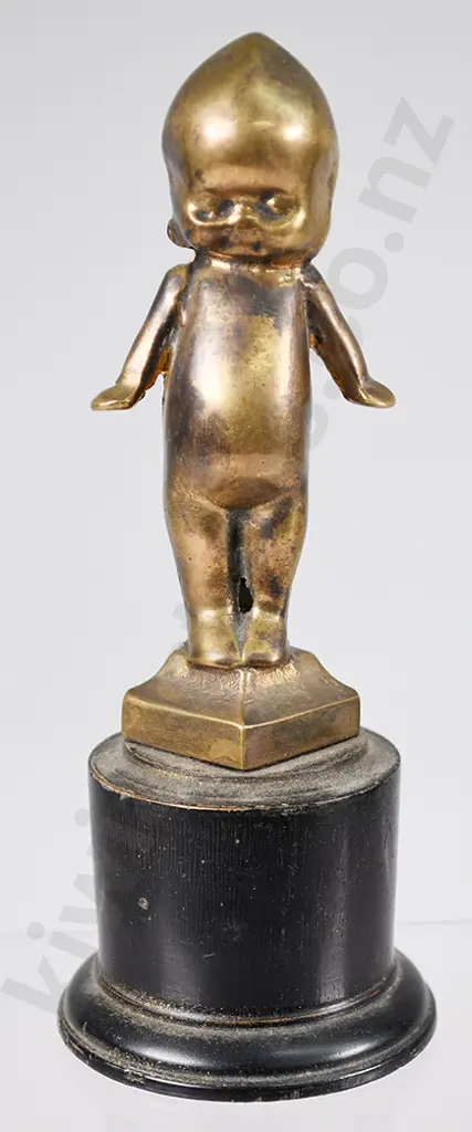 BRASS KEWPIE DOLL ON WOODEN STAND Image 1++