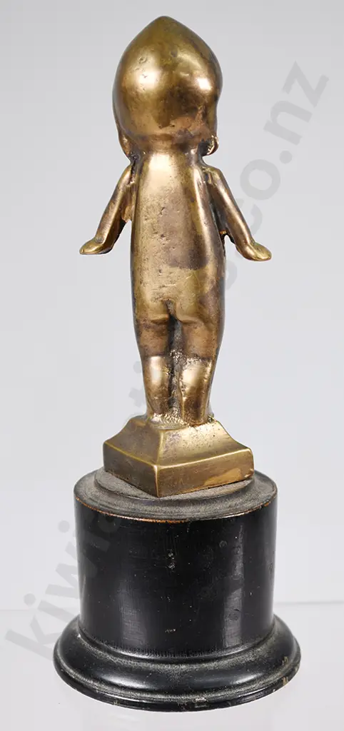 BRASS KEWPIE DOLL ON WOODEN STAND Image 1++