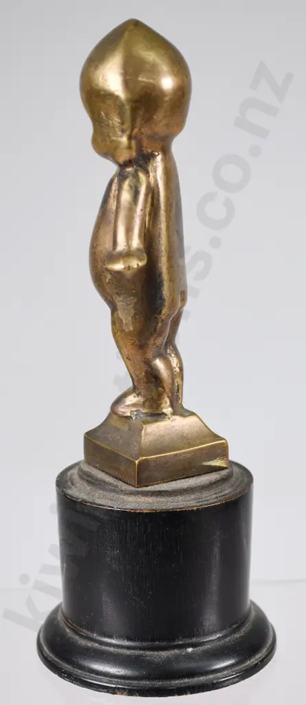 BRASS KEWPIE DOLL ON WOODEN STAND Image 1++