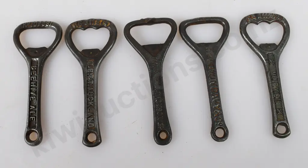 ASSORTED CAST IRON BOTTLE OPENERS Image 1++